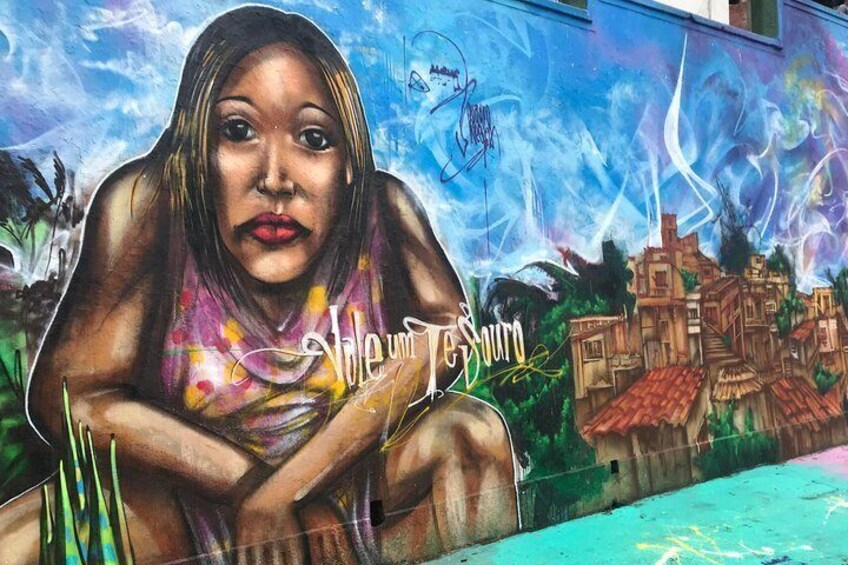 A mural with a person and a cityscape. 3
