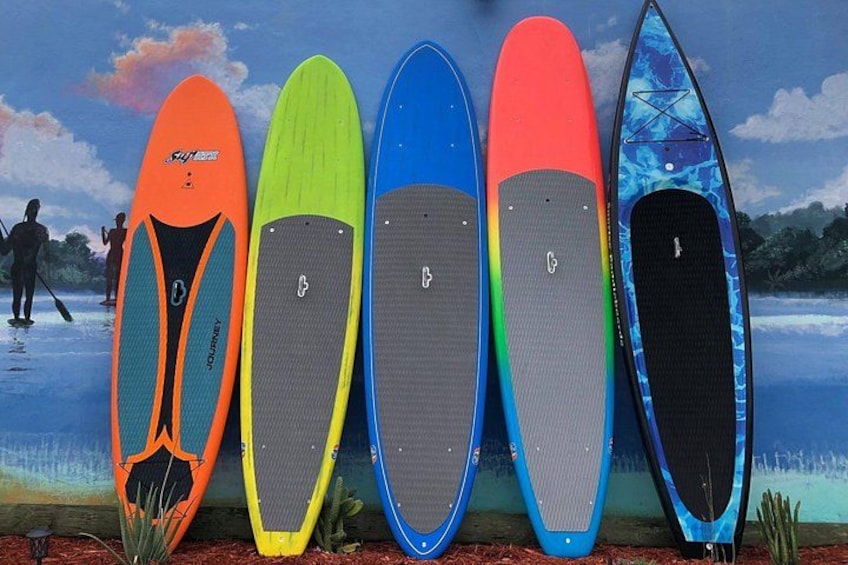 Five paddleboards in various colors. 2