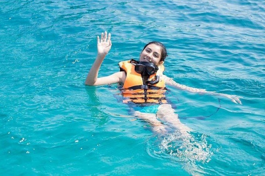 A person in a swimming pool wearing a life jacket and a snorkel. 3