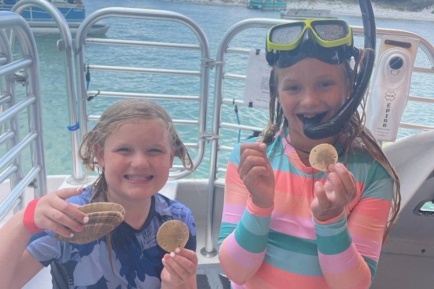 Two children holding waffle cones on a boat. 2