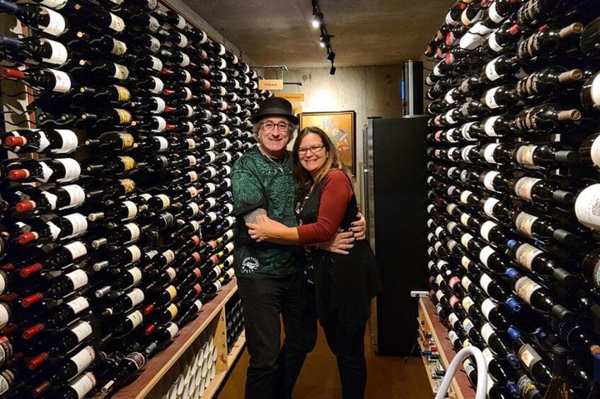A wine cellar with rows of wine bottles. 4