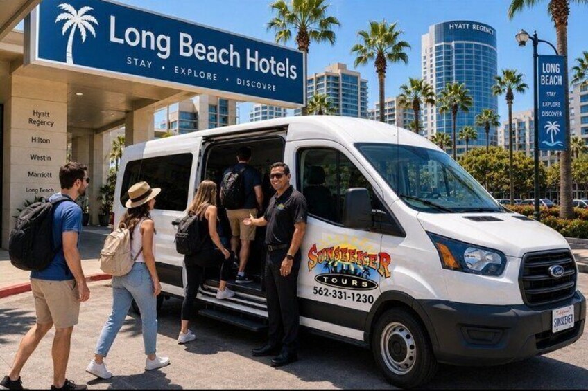 A tour bus with 'SunSeeker Tours' and contact number parked in front of Long Beach Hotels. 1