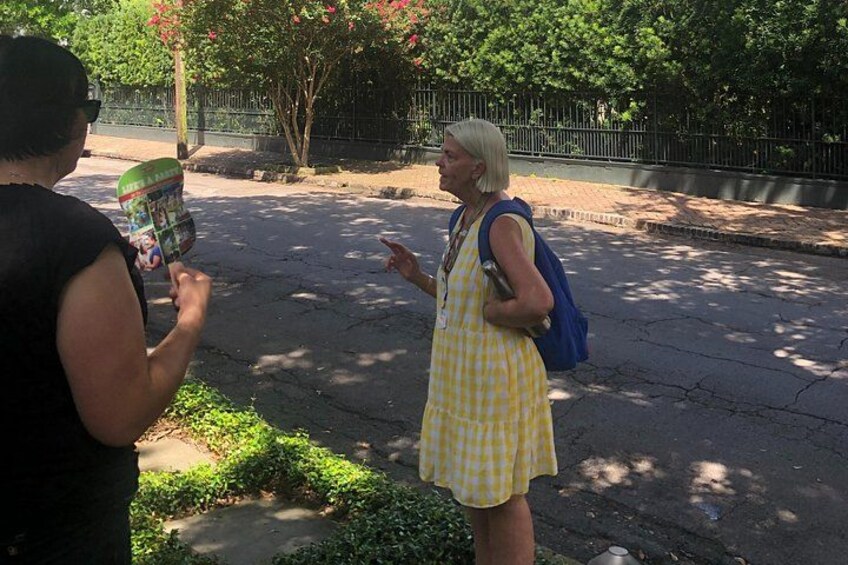 Two people on a street, one holding a magazine. 3