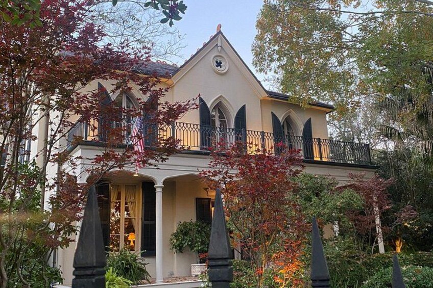 A large, ornate house with a balcony, surrounded by autumn foliage. 5