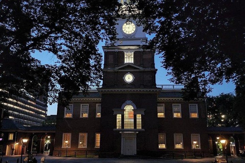A historic building with a clock tower, arched windows, and a central entrance. 3