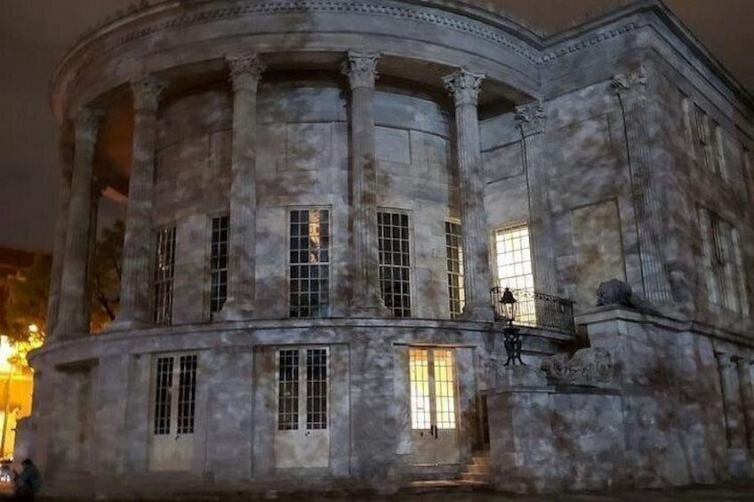 A classical building with columns and large windows. 4