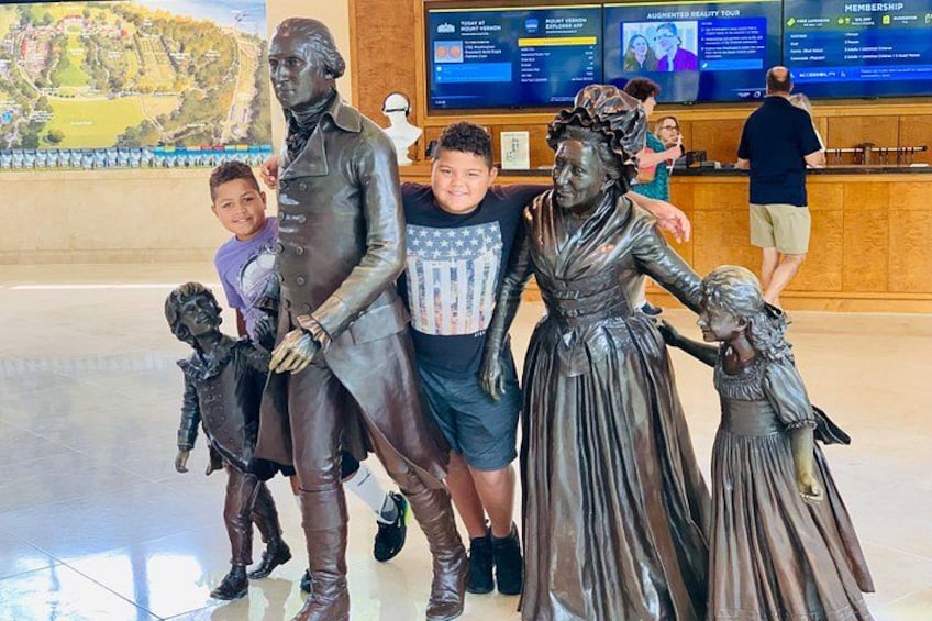 A bronze statue of a historical figure with children. 4