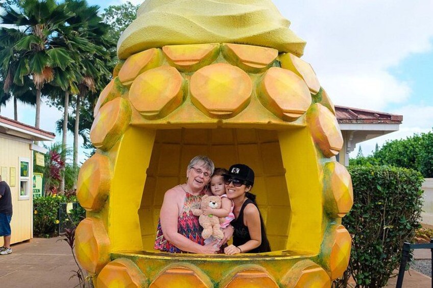 A yellow structure resembling a pineapple with a person and a child inside. 2