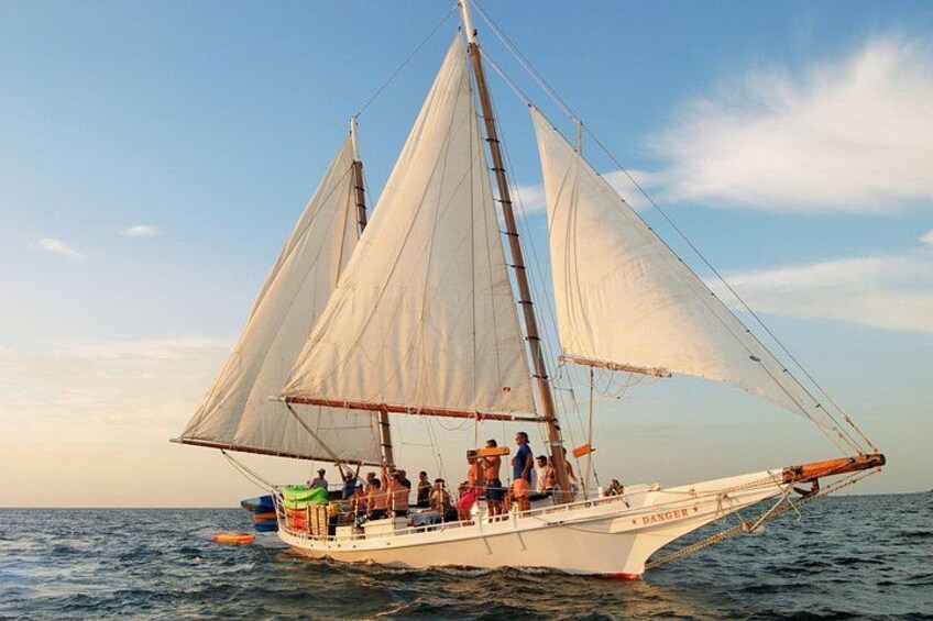 A sailboat with multiple sails on the water. 2