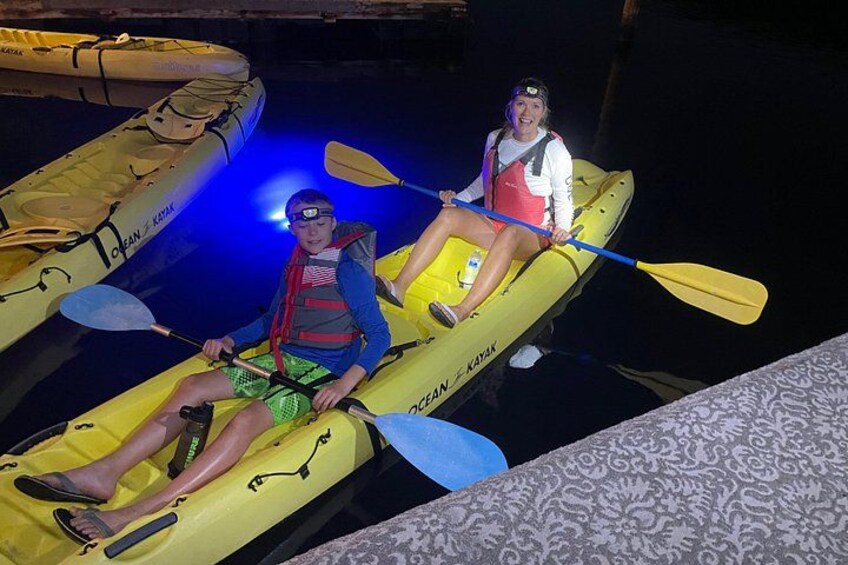 Two people in yellow kayaks on a dock. 3