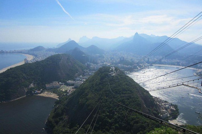 A cable car system, a river, and a mountainous landscape with a prominent peak. 3
