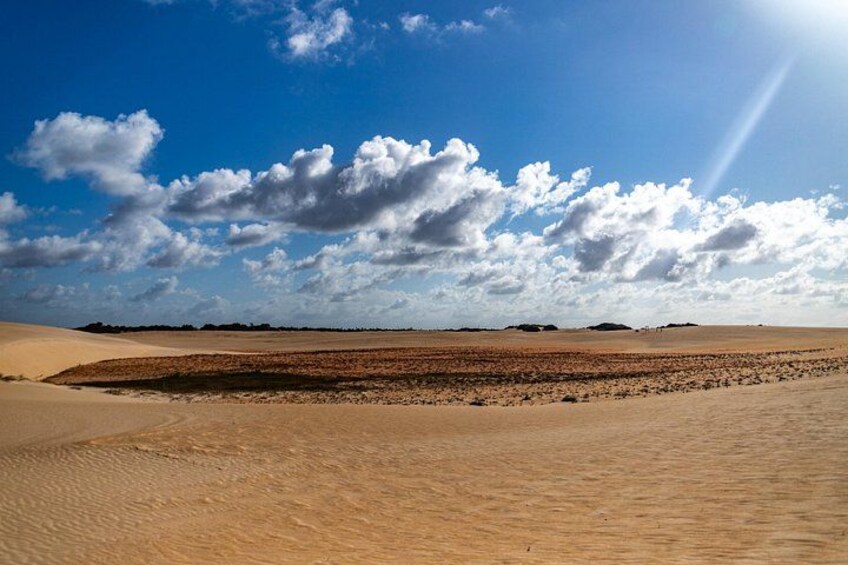 A desert landscape with sand dunes and a clear sky. 2