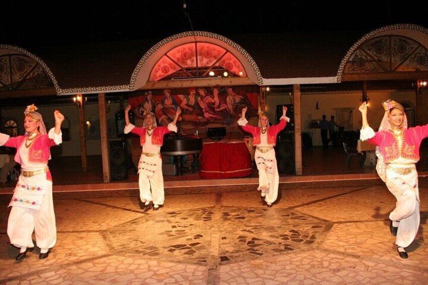 A dance performance with dancers in traditional attire. 2