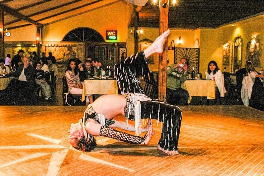 A person performing a handstand on a wooden floor in a restaurant. 4