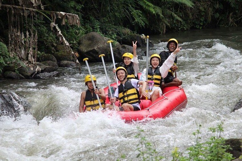 A group of people rafting on a river surrounded by greenery. 5