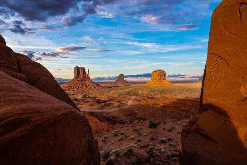 A desert landscape with prominent rock formations and a clear sky. 3