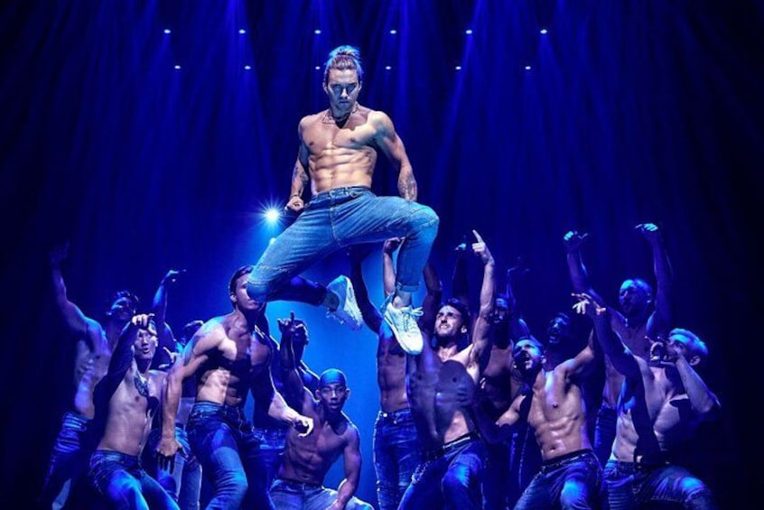A performer jumping with a crowd on stage. 5