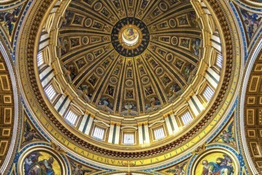 A detailed ceiling with a circular design, featuring intricate patterns and gold accents. 4