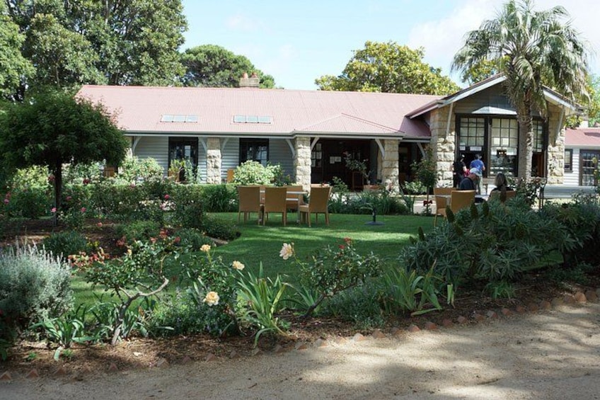 A house with a garden, a lawn, and a paved path. 3