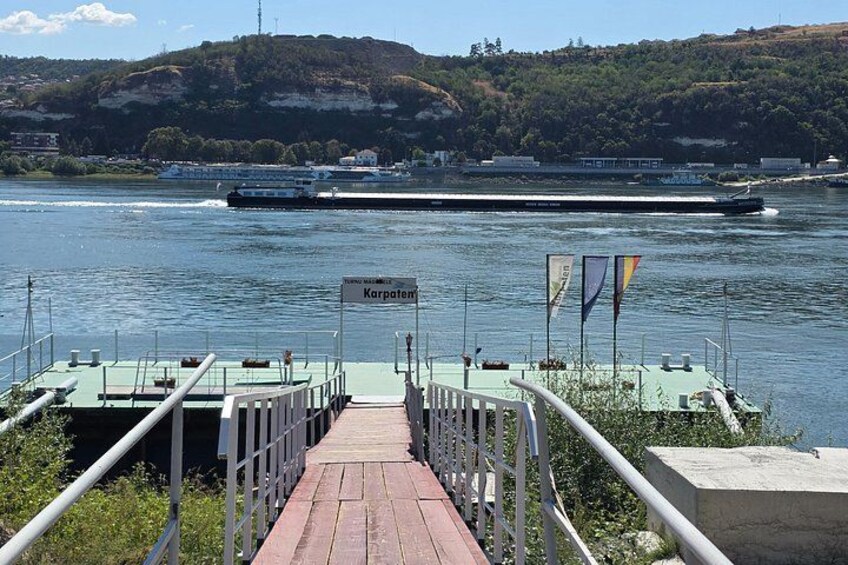 A river with a bridge, a boat, and a sign that reads 'Karpaten.' 1