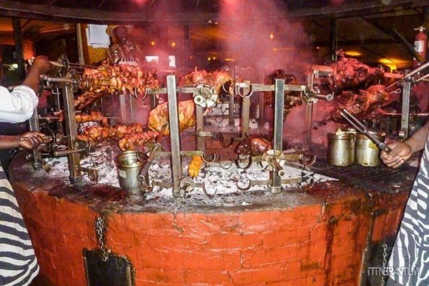 A large outdoor cooking setup with multiple grills and cooking utensils. 2