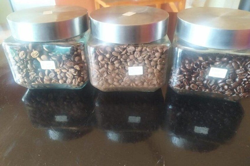 Three glass jars with metal lids containing coffee beans. 2