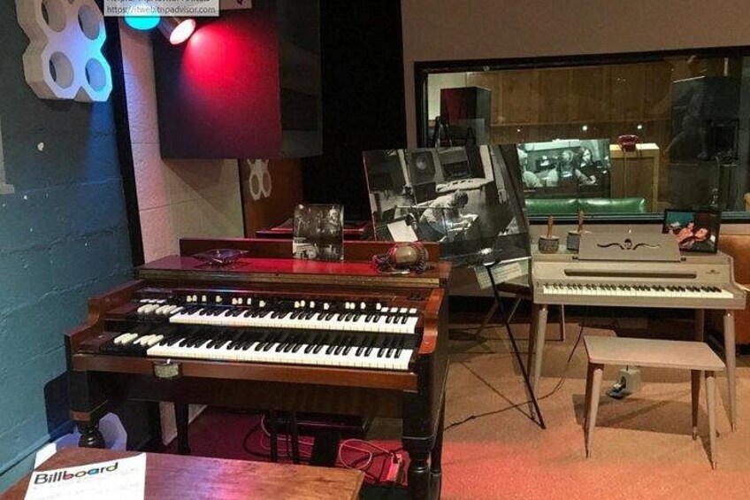 A music studio with various keyboards and electronic equipment. 1