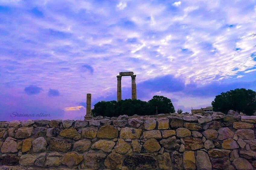 Ancient stone ruins with columns, set against a twilight sky. 5