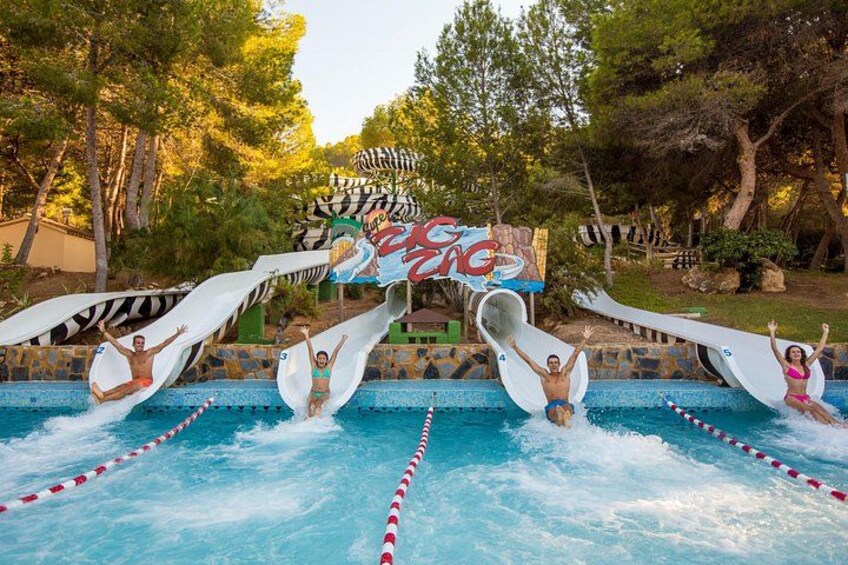 A water park with multiple water slides and a pool with lane dividers. 2