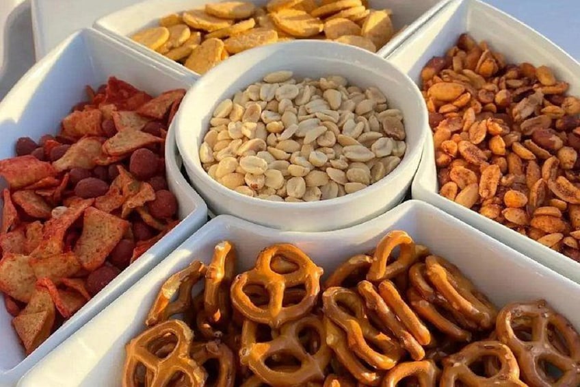 A variety of snacks in white containers. 2