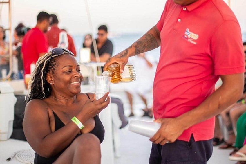 A person pouring a drink into a glass held by another person. 5