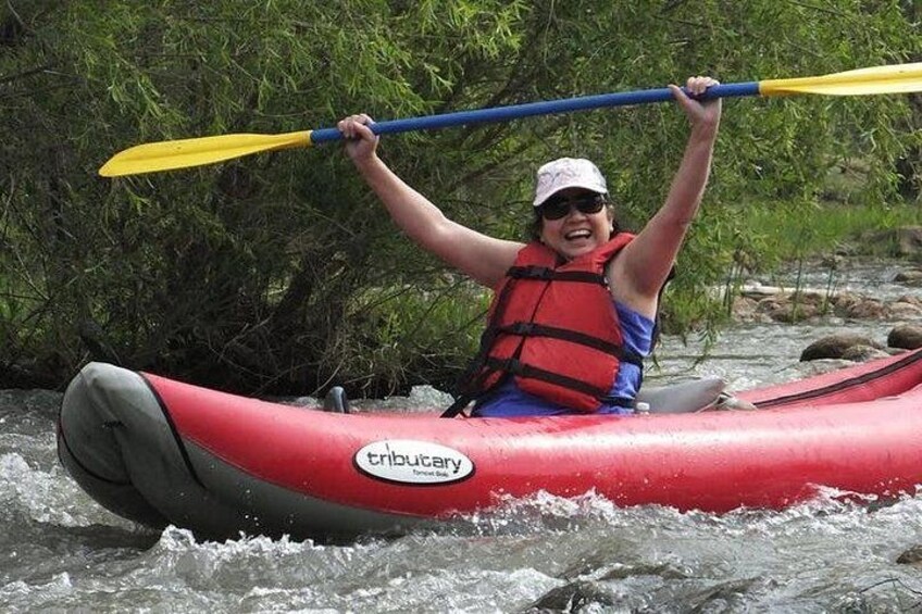 A person kayaking on a river. 4