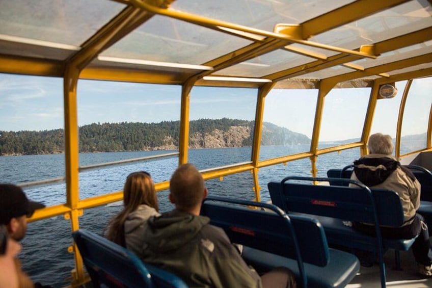 Travelers scout for Orca and humpback whales during a whale watching cruise from Vancouver. 3