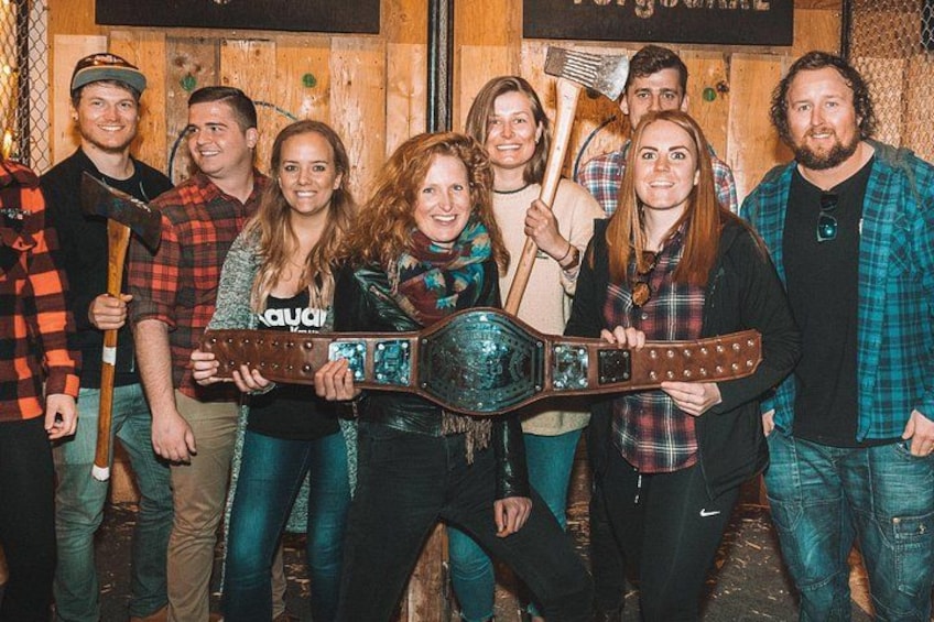 A group of people holding a large, ornate trophy. 2