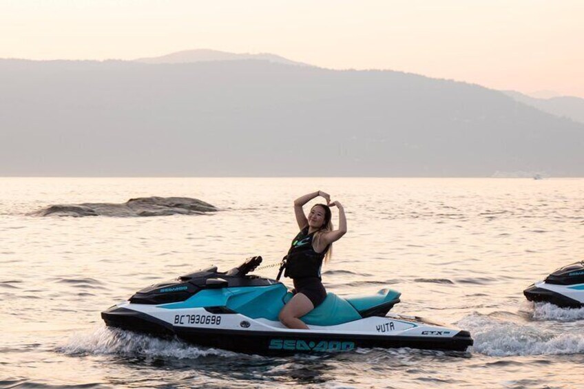 A person on a jet ski with mountains in the background. 4