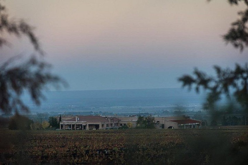 A coastal landscape with a house and fields. 3