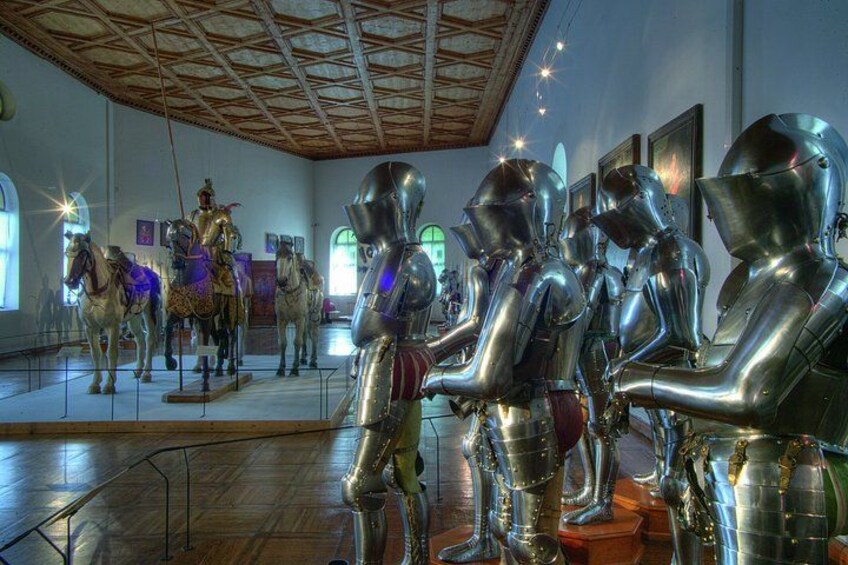A museum with medieval armor and horse statues. 5