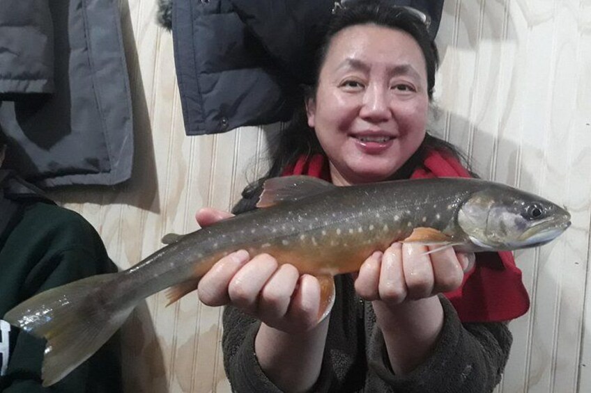 A person holding a fish. 5