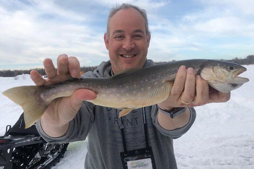 A person holding a fish. 4