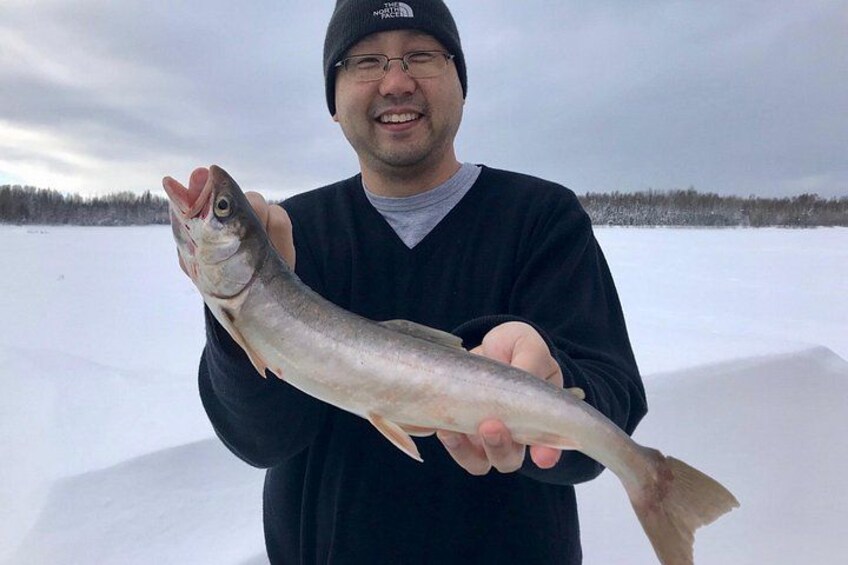 A person holding a fish. 1
