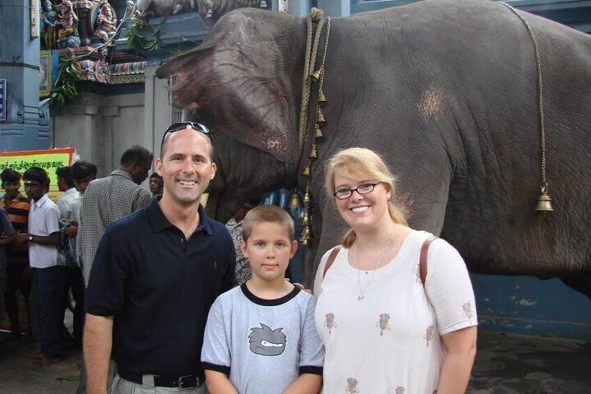 A family standing in front of a large elephant statue. 5