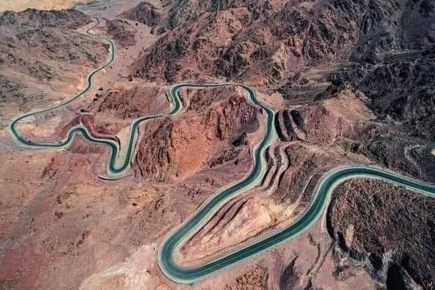 A winding road through a mountainous landscape. 3