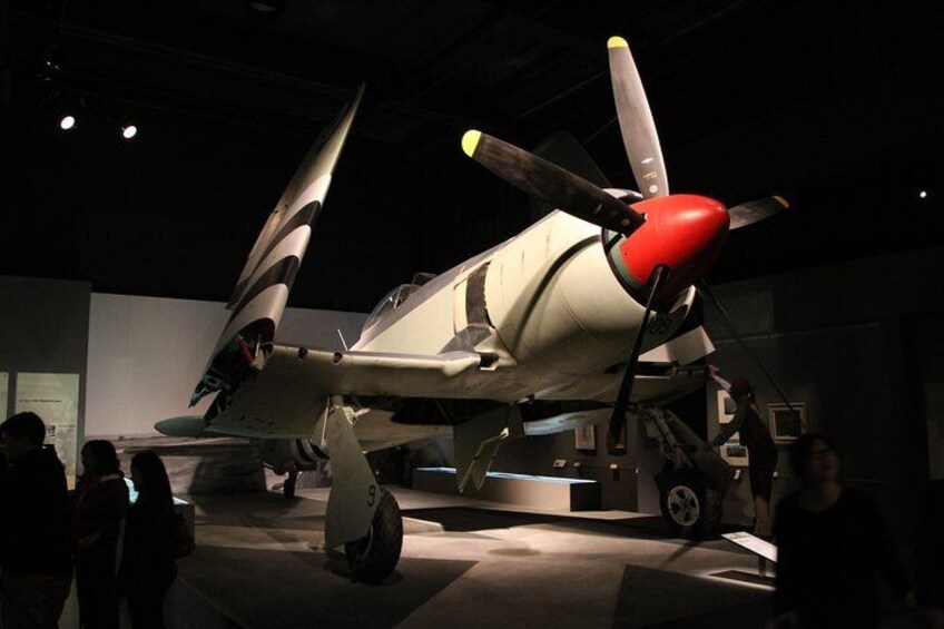 A vintage military aircraft on display in a museum. 4