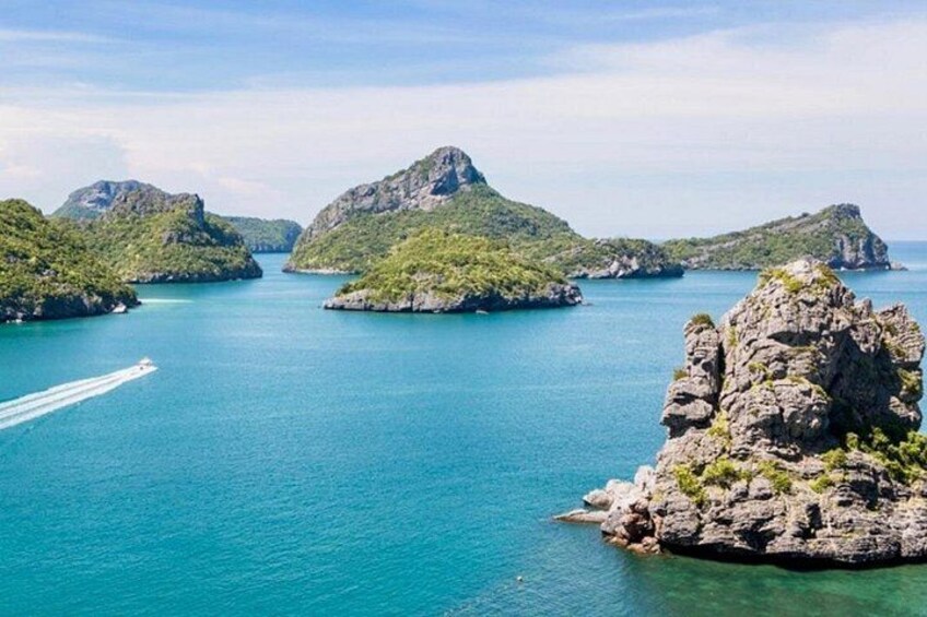 A coastal landscape with rocky islands and clear turquoise water. 2
