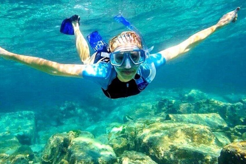 A person snorkeling underwater with fins and a snorkel. 3