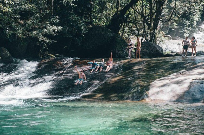 A waterfall with people enjoying the water. 3