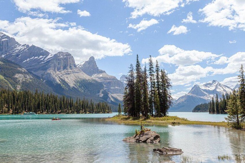 A mountain landscape with a lake, trees, and a clear sky. 1