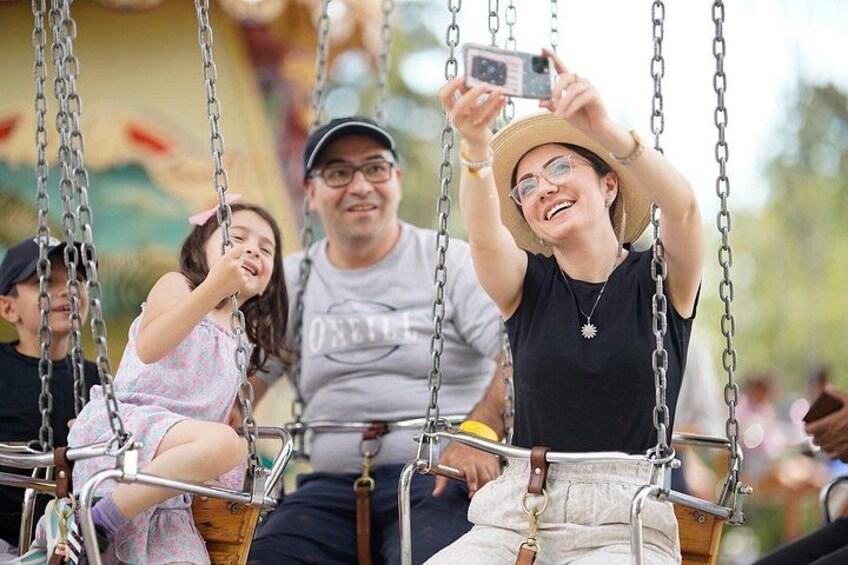 A family on a swing ride at an amusement park. 4