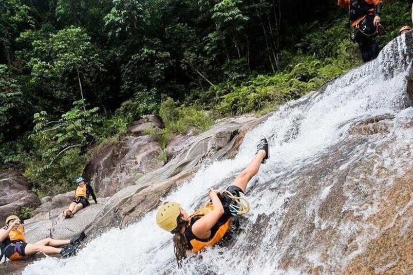 A person rappelling down a waterfall. 2