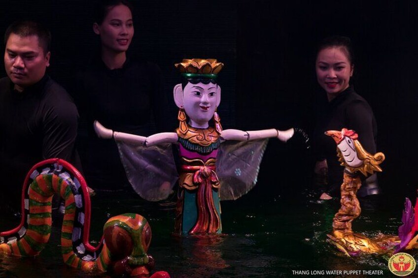 A puppet theater with a puppet in traditional attire, a dragon, and a mermaid. 2